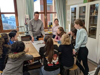 Schülerinnen versammelt rund um eine Werkbank